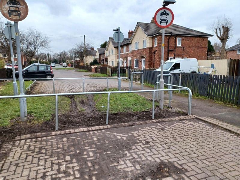 Green space with a newly fitted metal barrier around to protect it