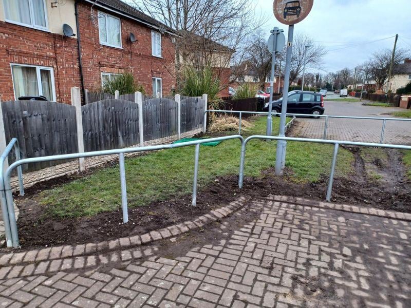 Green space with a newly fitted metal barrier around to protect it