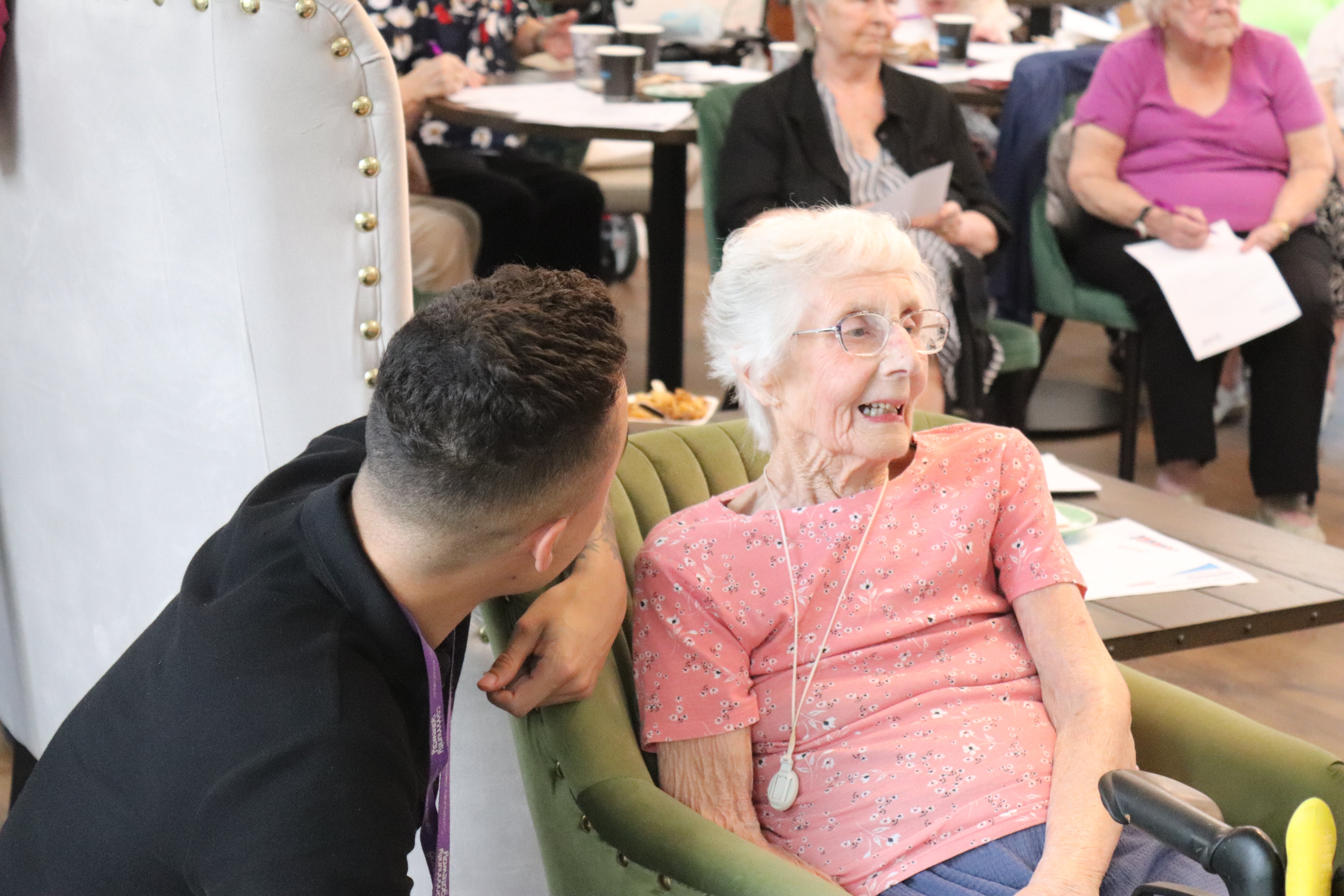 Showing a member of staff speaking with an older tenant at The Courtyards