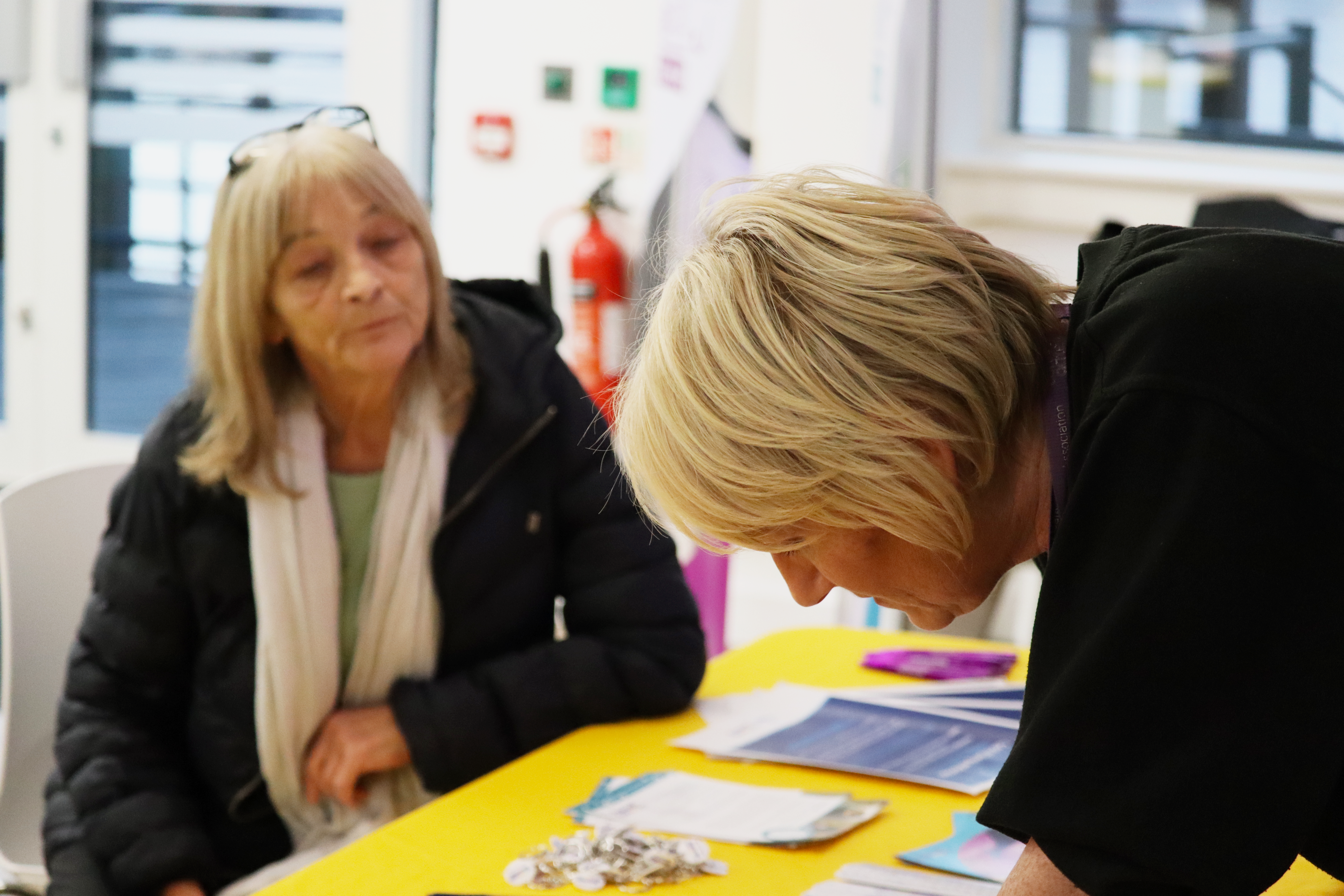 Showing a member of staff talking to a tenant at an event
