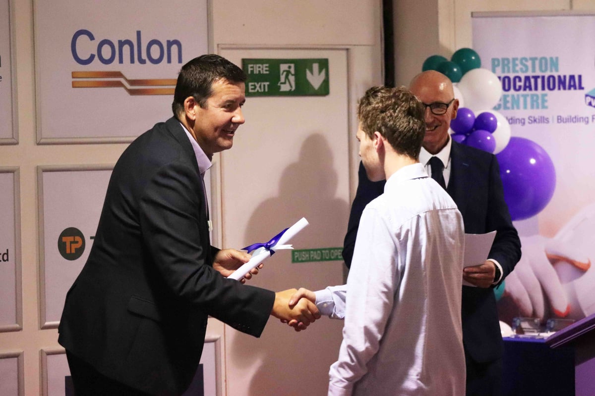 Rob Wakefield shaking hands with PVC student