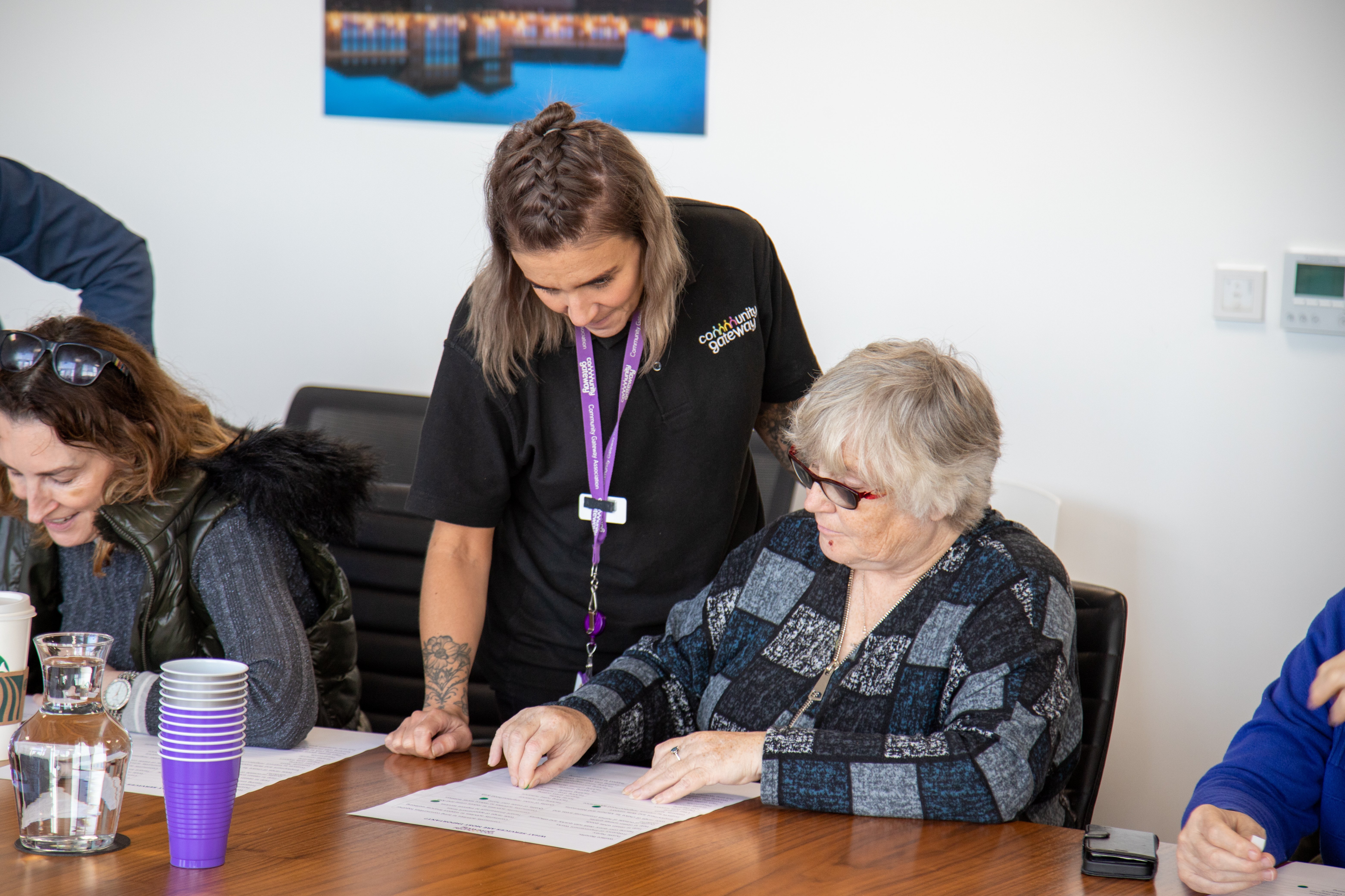 Showing a member of staff talking to a tenant at The Big Conversation