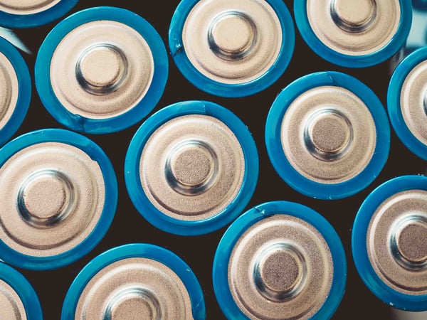 high-angle-shot-group-blue-batteries-surface